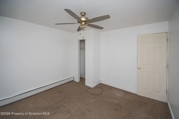 a view of a room with a ceiling fan