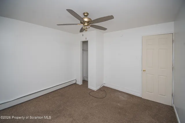 a view of a room with a ceiling fan