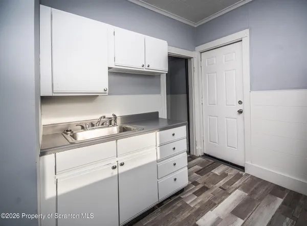 a kitchen with granite countertop white cabinets and white appliances