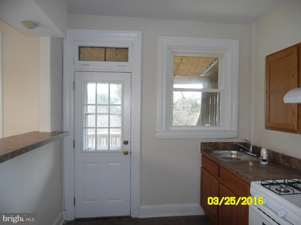 3003 Batavia Avenue Baltimore, MD 21214 - Photo 6 of 23 a bathroom with a granite countertop sink and a window