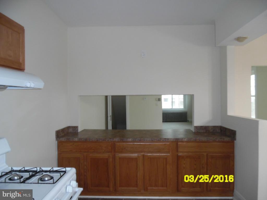 3003 Batavia Avenue Baltimore, MD 21214 - Photo 7 of 23 a kitchen with a stove and a refrigerator