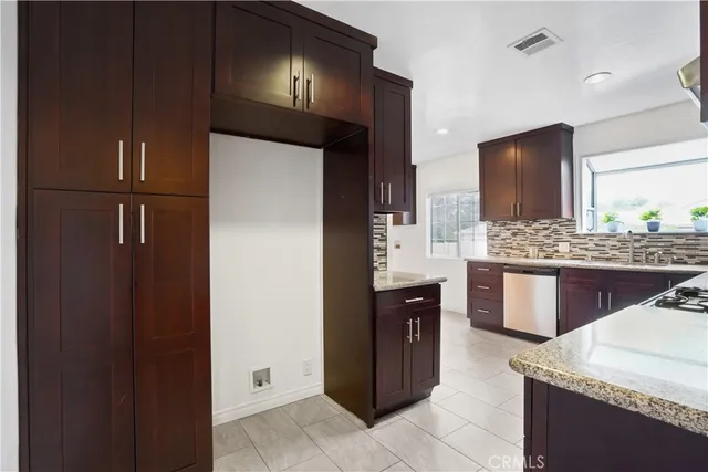 a kitchen with stainless steel appliances granite countertop a refrigerator and a sink