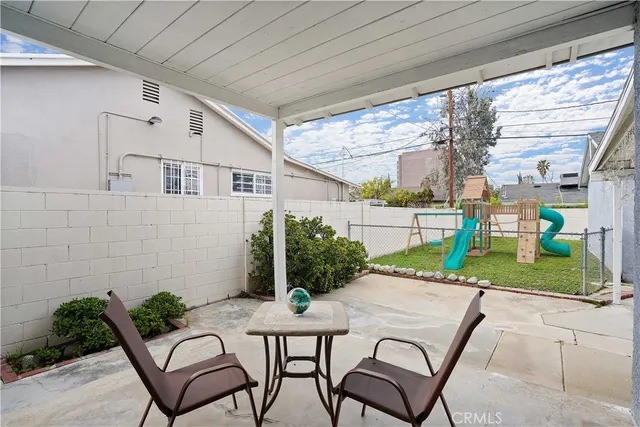 a patio with plants and outdoor seating
