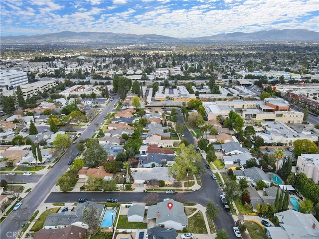 an aerial view of residential houses with city view