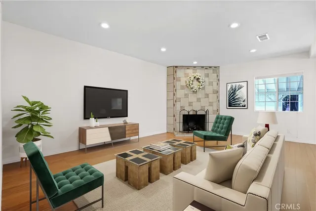 a living room with furniture a fireplace and a flat screen tv