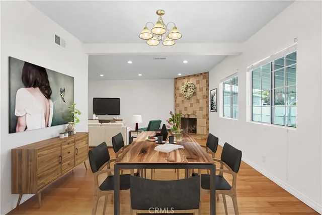a view of a dining room with furniture a rug and a flat screen tv