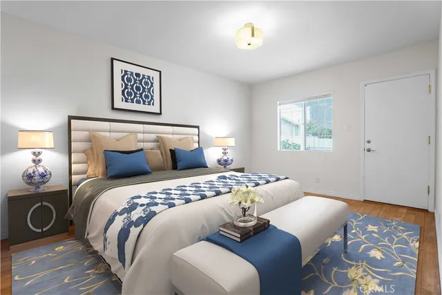 a bedroom with a bed and wooden floor