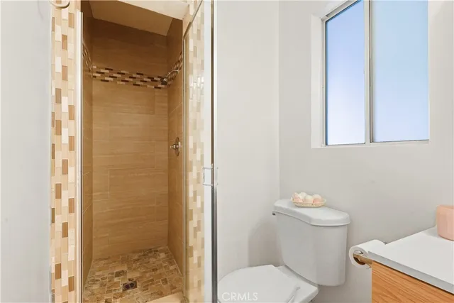 a white toilet sitting next to a bathroom sink