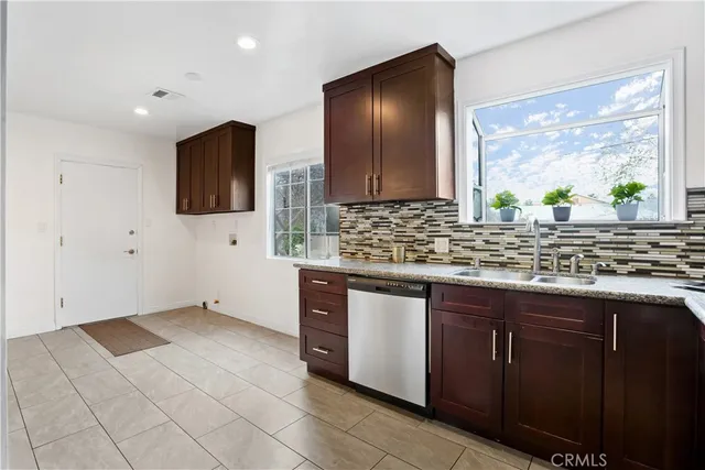 a kitchen with a sink window and cabinets