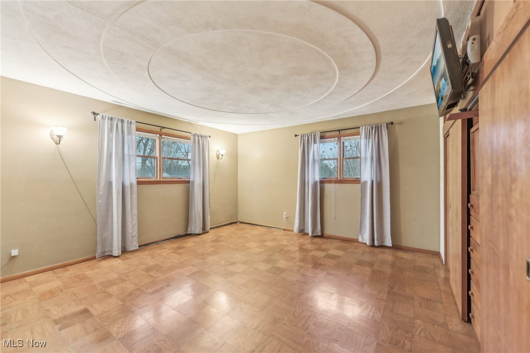 6326 Murray Ridge Road Elyria, OH 44035 - Photo 32 of 49 Empty room with parquet floors and a wealth of natural light