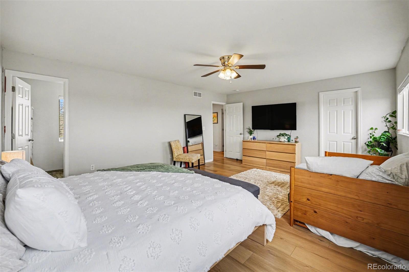 9704 Marmot Ridge Circle Littleton, CO 80125 - Photo 13 of 21 a spacious bedroom with a bed and a flat screen tv