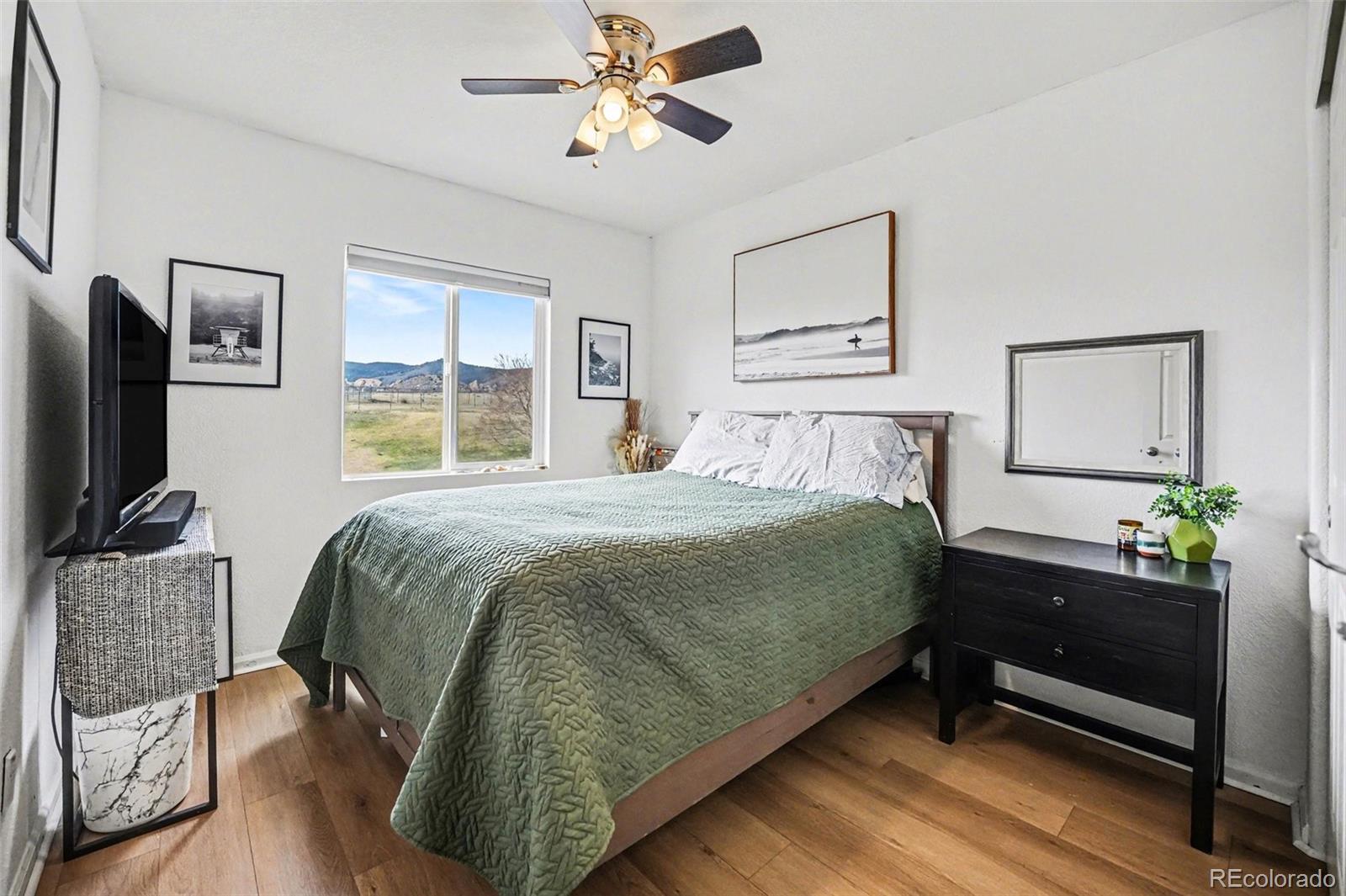 9704 Marmot Ridge Circle Littleton, CO 80125 - Photo 15 of 21 a bedroom with a bed dresser and window