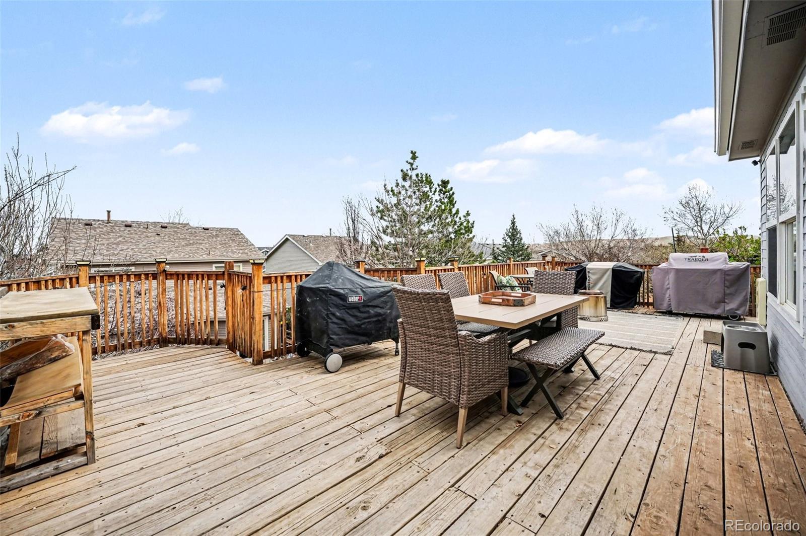 9704 Marmot Ridge Circle Littleton, CO 80125 - Photo 19 of 21 a terrace of a house with wooden floor outdoor seating