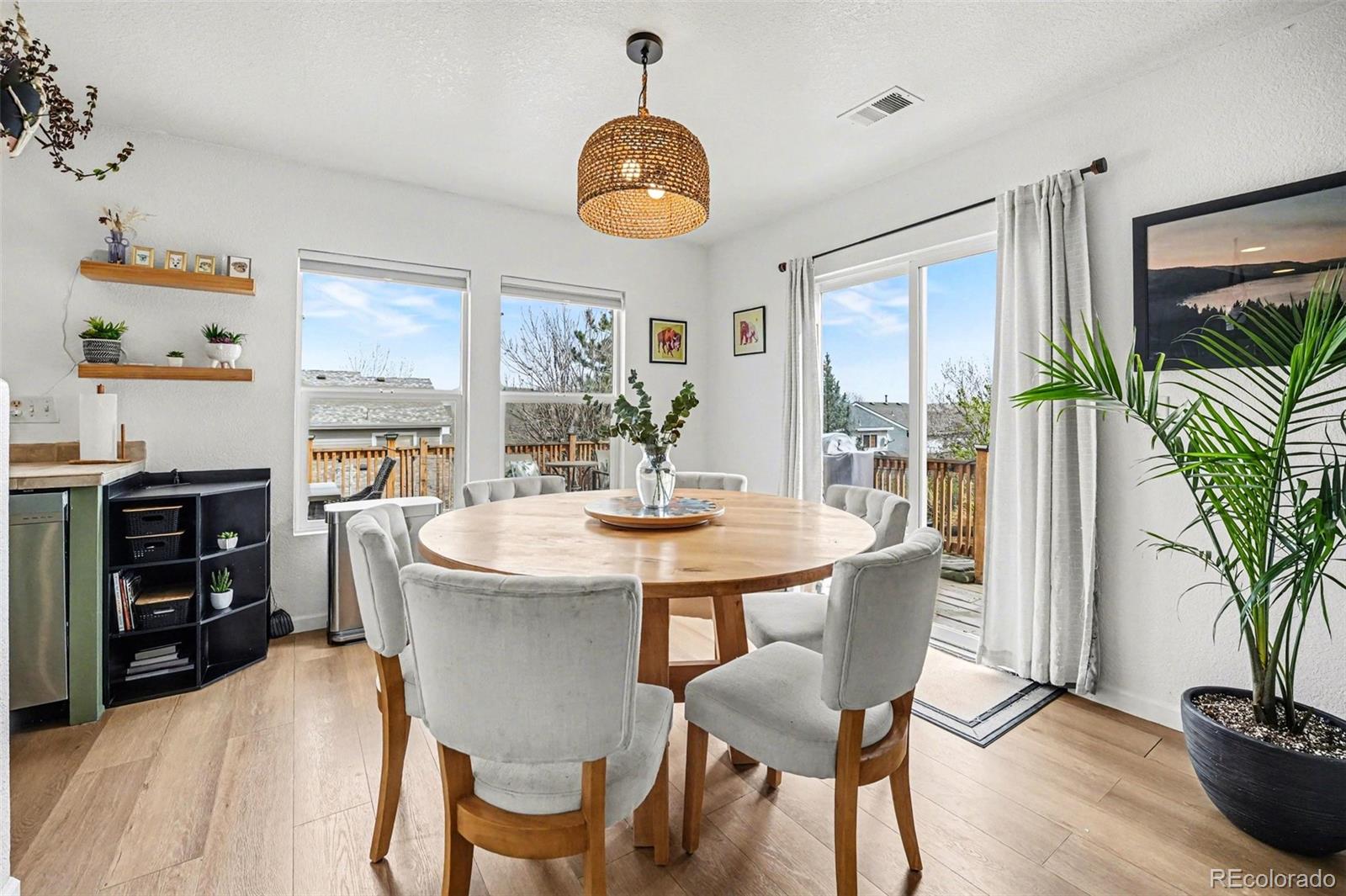 9704 Marmot Ridge Circle Littleton, CO 80125 - Photo 6 of 21 a view of a dining room with furniture and a potted plant