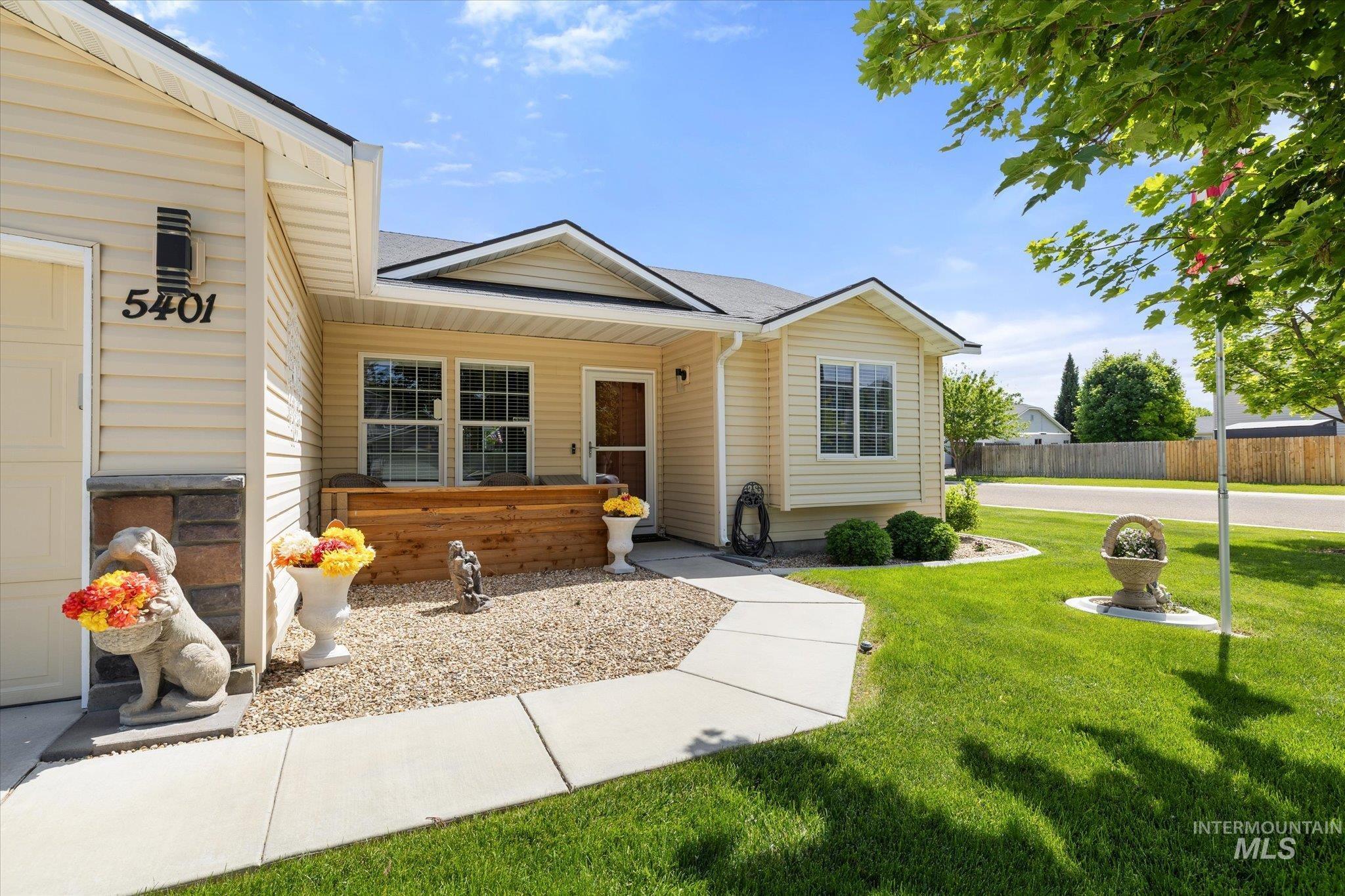 5401 Barkley Way Caldwell, ID 83607 - Photo 4 of 35 Cream-colored siding exterior featuring stone veneer accents