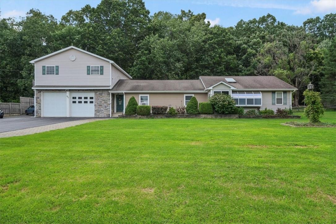 a front view of a house with a garden