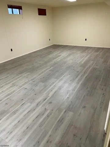 an empty room with wooden floor