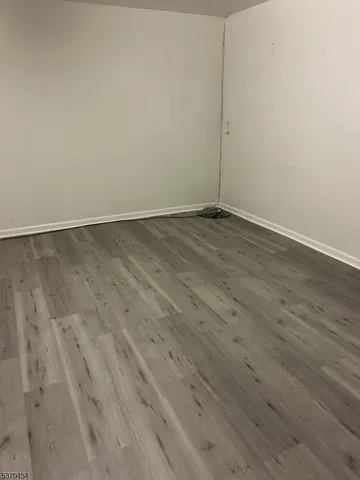 an empty room with wooden floor