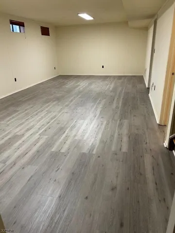 an empty room with wooden floor