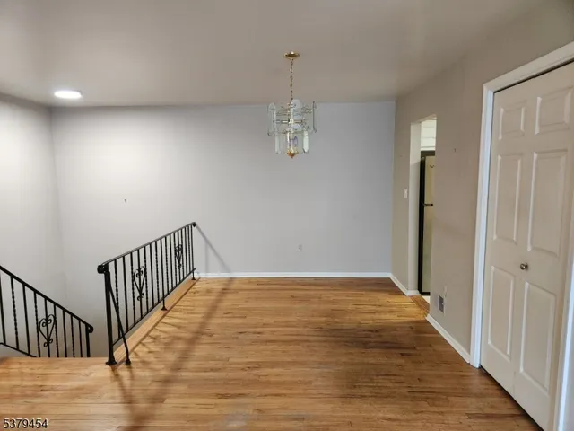 a view of hallway with wooden floor