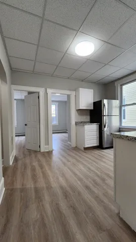 a view of a kitchen with a sink and a refrigerator