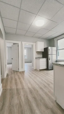 a view of a kitchen with a sink and a refrigerator