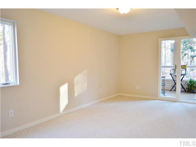 2405 Countrywood Road Raleigh, NC 27615 - Photo 18 of 25 The basement has two bedrooms in addition to the media/bonus room. This bedroom has a view of the lovely, natural area in back. Both bedrooms open to the solarium/studio area. The other bedroom is similar to this. All the paint is fresh. Bedroom