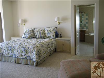 70248 Calico Road Rancho Mirage, CA 92270 - Photo 4 of 9 a bedroom with a bed and a table