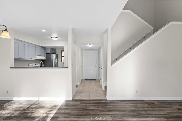 a view of a room with wooden floor and white walls