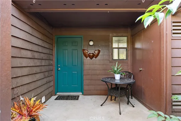 a backyard of a house with table and chairs