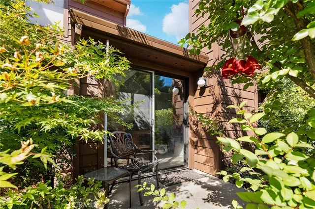 an aerial view of residential houses with outdoor space and trees