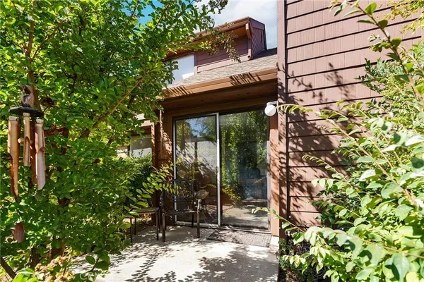 a view of a chairs and table in a backyard