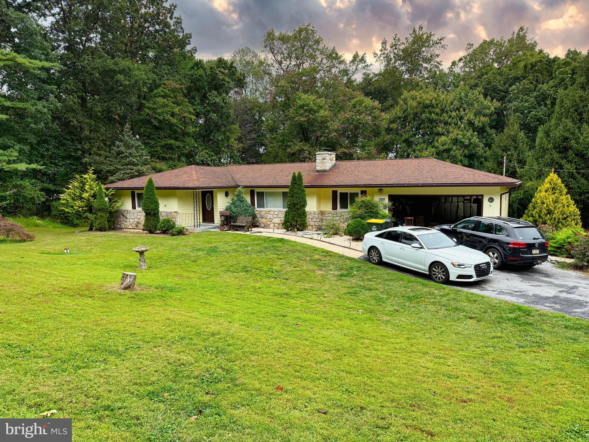 1667 Beacon Hill Road Downingtown, PA 19335 - Photo 1 of 23 a front view of a house with garden