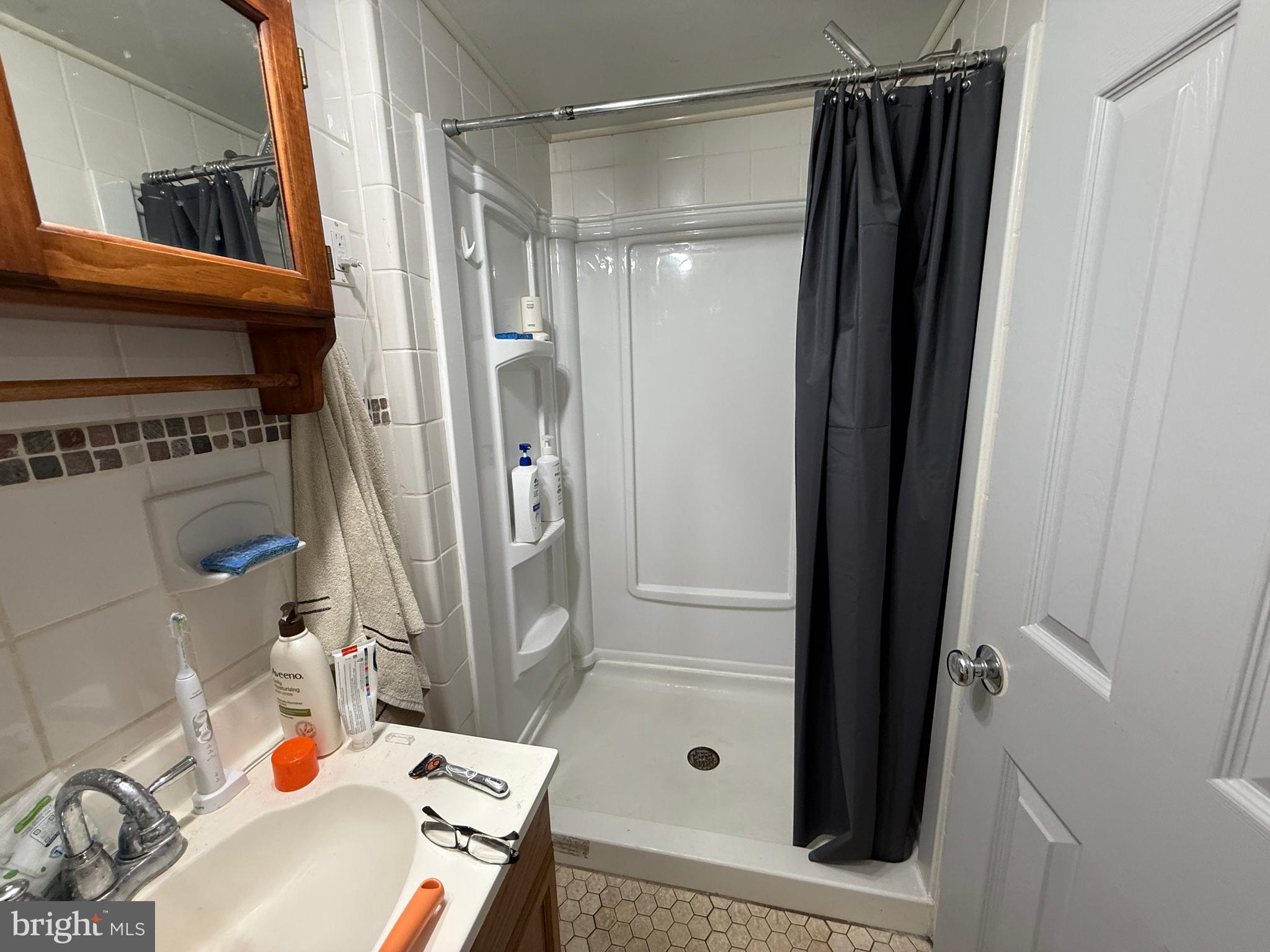 1667 Beacon Hill Road Downingtown, PA 19335 - Photo 20 of 23 a bathroom with a bathtub and a shower