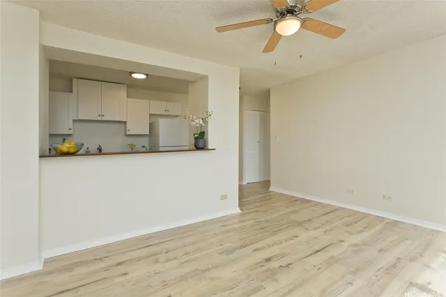 a view of a kitchen with a sink and a refrigerator