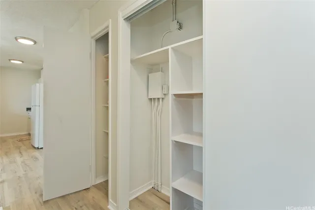 a view of walk in closet with empty racks