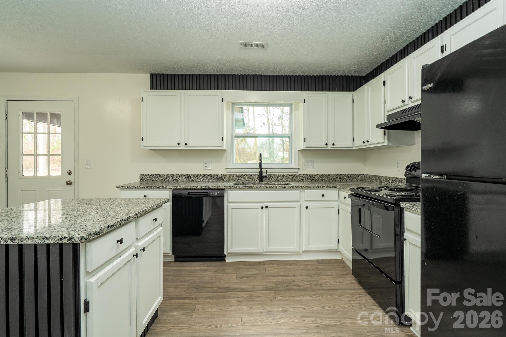 3115 Crestview Drive Florence, SC 29501 - Photo 14 of 35 a kitchen with granite countertop a sink stainless steel appliances and white cabinets
