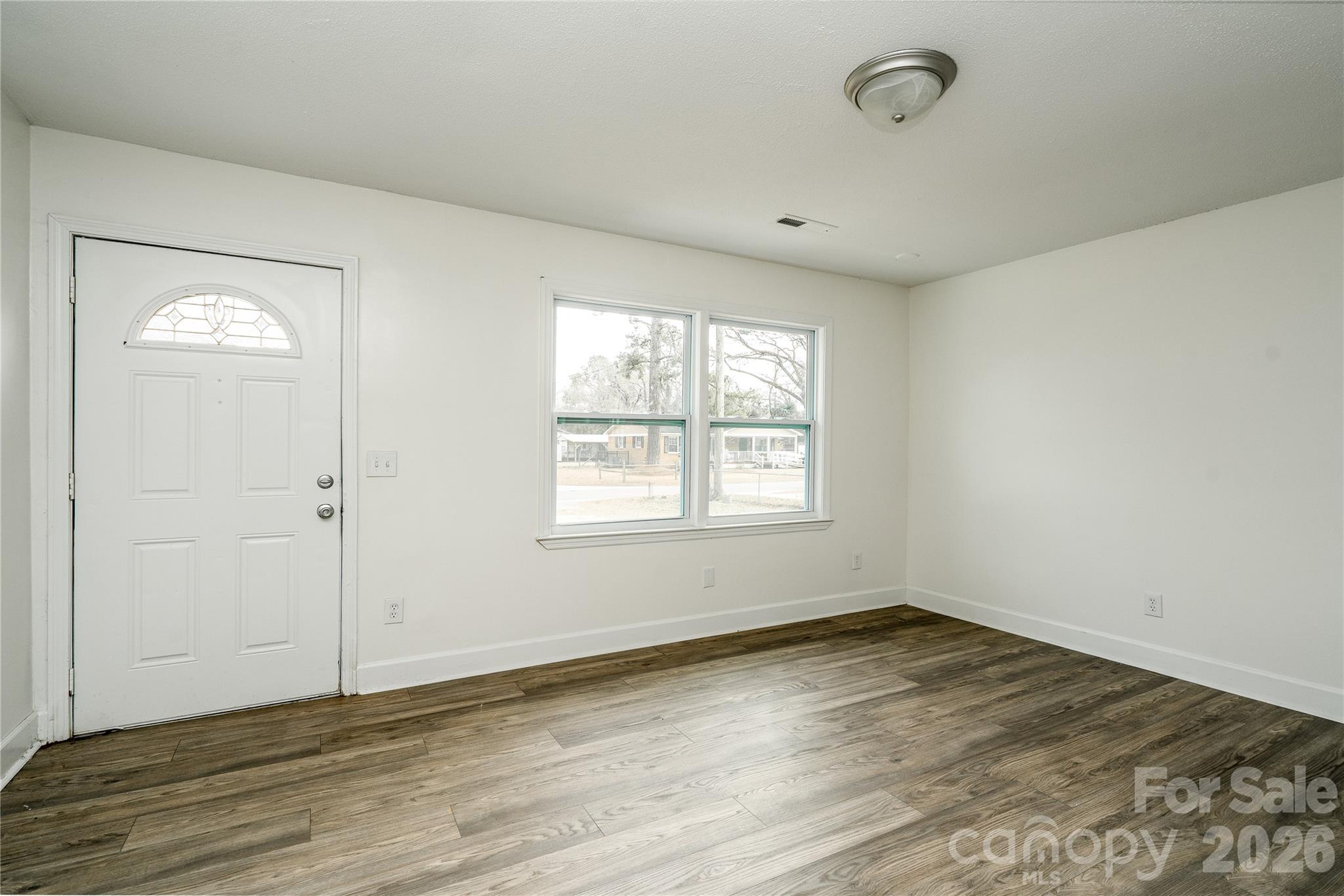 3115 Crestview Drive Florence, SC 29501 - Photo 9 of 35 an empty room with wooden floor and windows