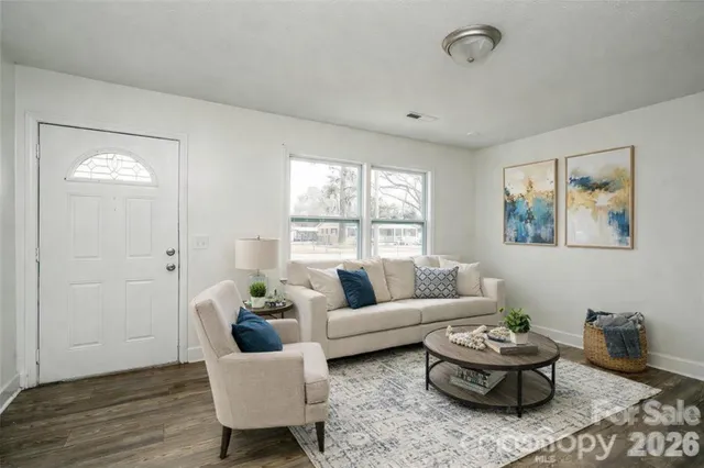 a kitchen with granite countertop a sink stove and cabinets