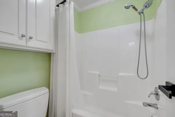 a view of a hallway with wooden floor and stairs