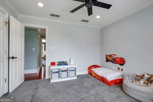 a bedroom with a large bed and a chandelier