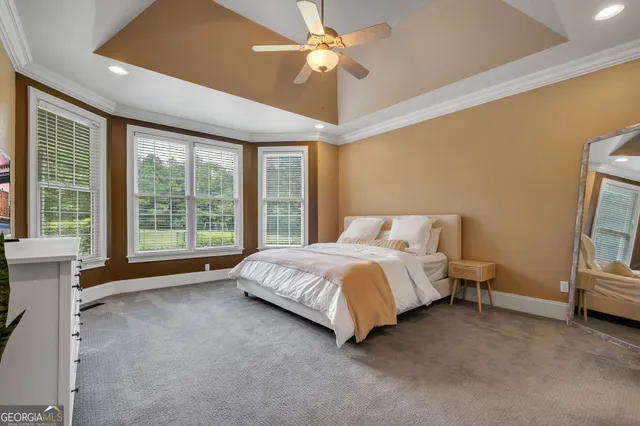 a spacious bathroom with a granite countertop sink a toilet a mirror and shower