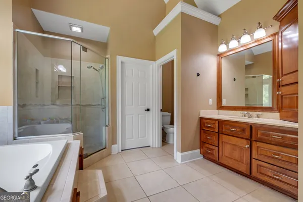 a bathroom with a sink mirror and toilet