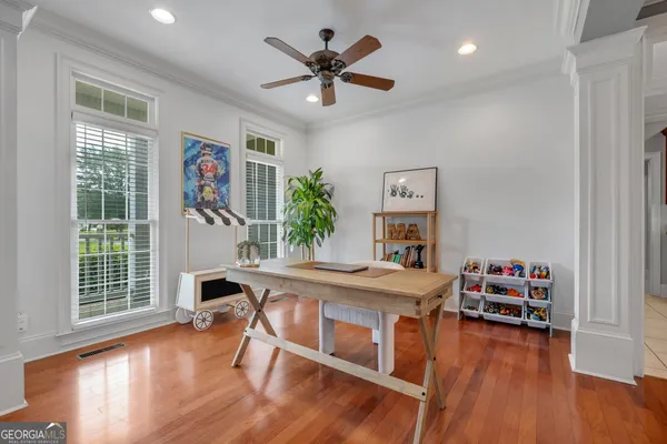 a living room with furniture and wooden floor