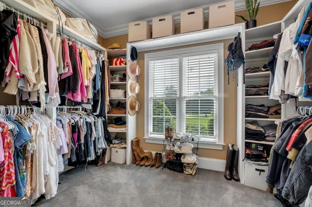 a living room with furniture a fireplace and a large window