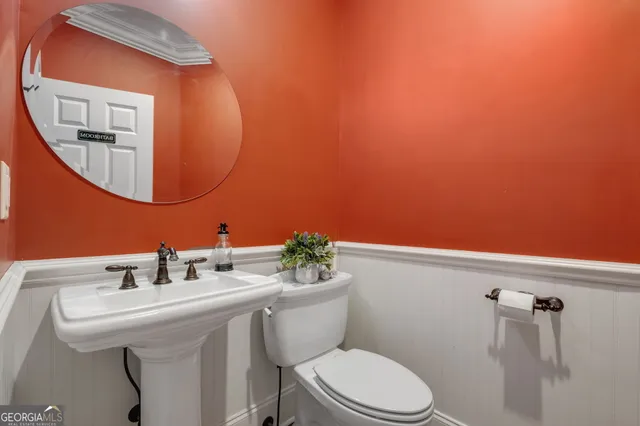 a living room with furniture a chandelier and a large window