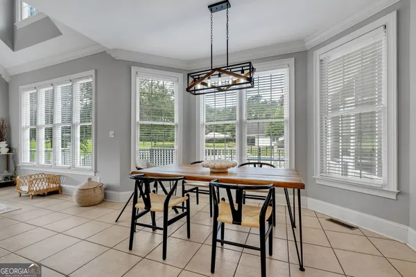 a view of a dining room with furniture window and outside view