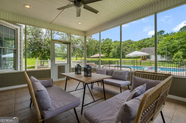 a view of swimming pool with outdoor seating and yard