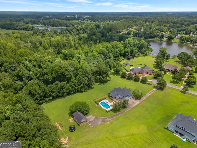an aerial view of a houses with a lake
