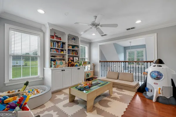 a living room with furniture and a book shelf